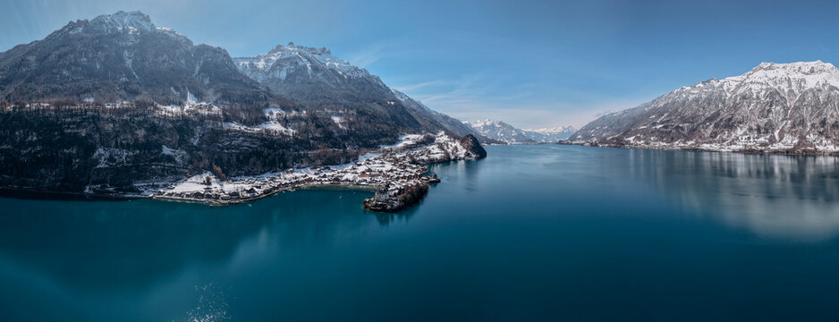 Aerial Winter View of Iseltwald Village on Lake Brienz with Snowy Swiss Alps