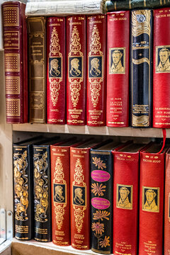 Shelf of French literary classics in a charming antiquarian bookshop inside one of Paris's historic covered passages, in Paris, France