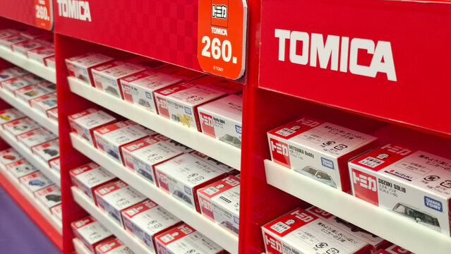 Assorted Tomica diecast model car boxes displayed on retail store shelves for illustrative editorial use in toy industry and hobby collection on March 28, 2026 in Bangkok, Thailand