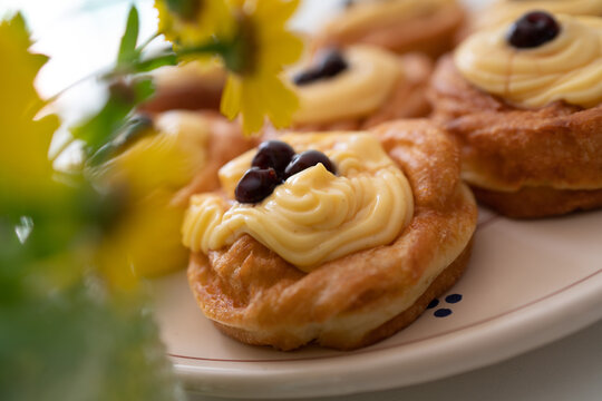 Zeppole di San Giuseppe. A traditional Italian pastry filled with custard and topped with black cherries, typically served on Father's Day. Traditional pastry.