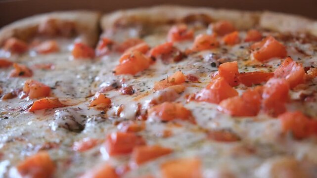 Perfectly baked margherita pizza features vibrant tomato sauce, creamy mozzarella slices, Herbes de Provence and spices.