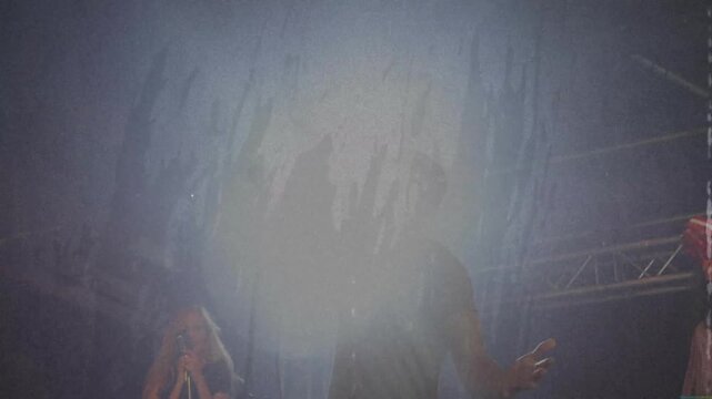 Back beam rising, lead singing, raising arm, backup singing, shaking tambourine to boost chorus