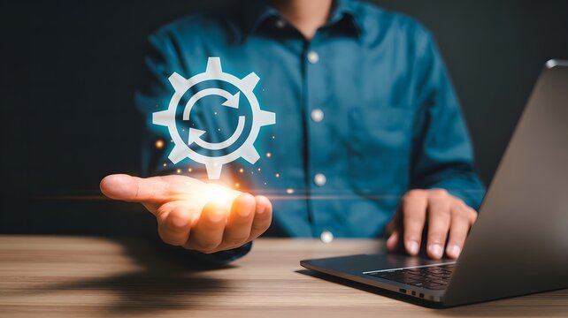 Businessman holding glowing gear symbol of refresh and update process, technology concept.