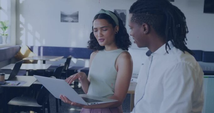 Vertical video: Pointing woman holding laptop and showing to man for review in office, binary