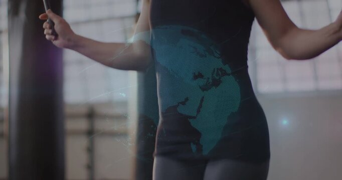 Vertical video: Woman starting skipping from rope, cam rising, globe spinning over chest for cardio