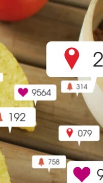 Vertical video: Shot panning right sparking likes over cheese chip tomato on wood boosting food ads