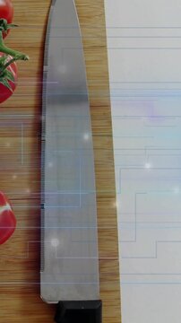 Vertical video: Blue grid rising, serrated knife sliding, centering, readying tomatoes for slicing