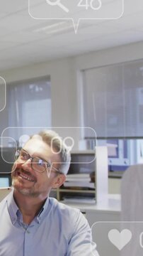 Vertical video: Device pinging, man looking up smiling while overlays multiplying, showing growth