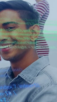 Vertical video: Male dev smiling and turning while code revealing coworker in tech lab for demo