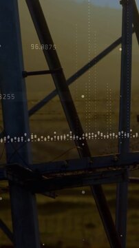 Vertical video: Data overlay starting, camera panning over metal lattice at fields, tracking data