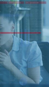 Vertical video: Woman tapping laptop starting tech overlay with MAC or IP and red alert, responding