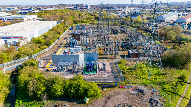 Aerial view of a modern electrical substation with transformers and insulators. Insulators, transmission line and other electrical distribution components in an electrical substation.