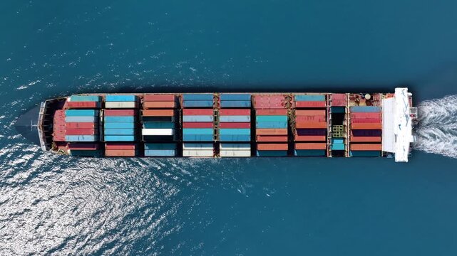 Container ship sailing through clear waters, transporting valuable cargo across major trade routes for international shipping markets