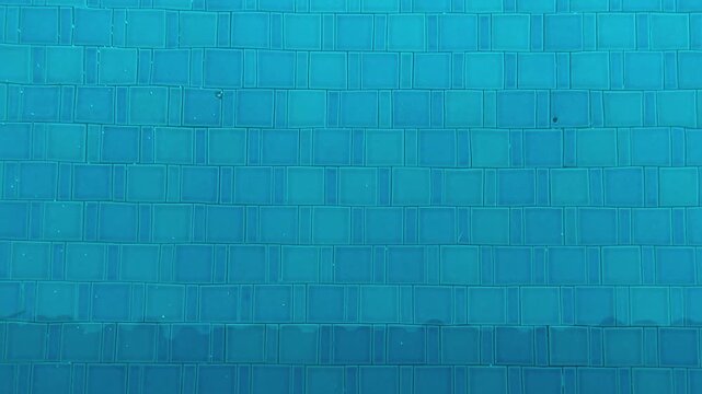 Swimming pool blue water with tile pattern background in clean outdoor leisure setting