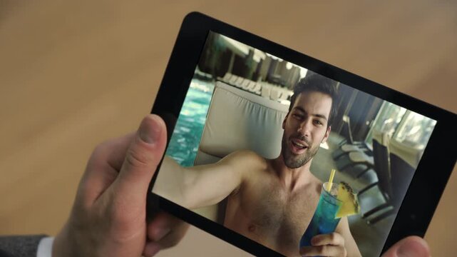 Pool man call tablet screen at vacation closeup. Guy holding tab computer online
