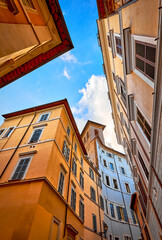 Rome, Italy. Old street in downtown with antique buildings. Evening rome city cityscape. Low angle view perspective at roman houses italian architecture.