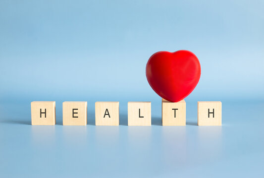 Red heart with health word on wooden blocks for wellness concept