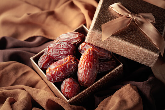 Dates fruits in golden gift box.