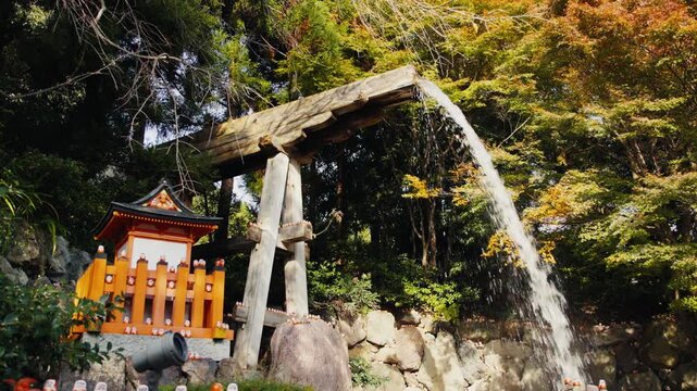 Scenic waterfall and small shrine in japanese garden