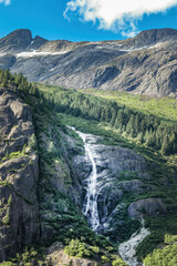 Majestic Alaska waterfall near Juneau framed by forest and mountains