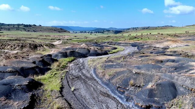 Aerial pass above dry stream erosion caused by poor grazing practices