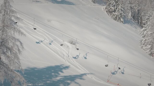 Serene snow-covered mountain slopes with ski lift in Zillertal. Perfect for winter sport and travel documentaries.