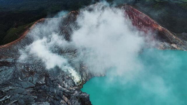 Cinematic aerial drone footage of Mount Ijen featuring its dramatic crater, turquoise sulfur lake, and volcanic landscape.
