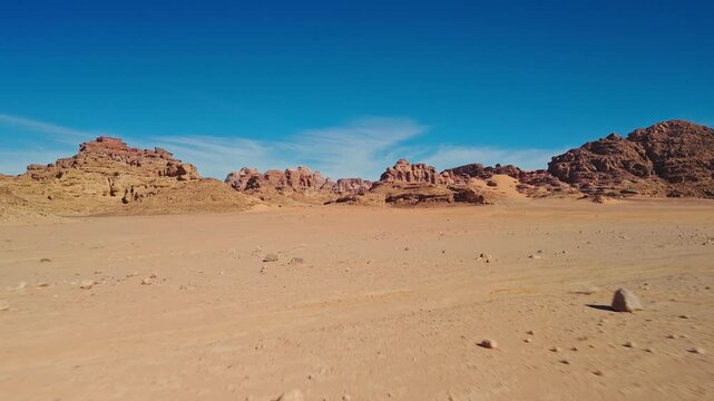 Fast drone fly over rocky desert with mountains in wadi rum in jordan