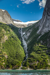 Majestic Alaska waterfall near Juneau framed by forest and mountains