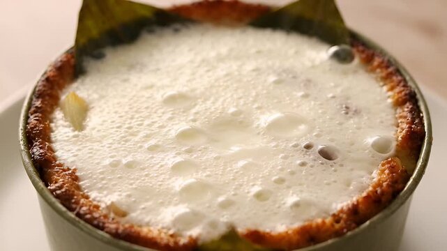 Creamy Culinary Delight: A close-up shot of a single-serving ramekin brimming with a freshly baked, bubbling culinary creation, its golden-brown crust promising a delectable taste.