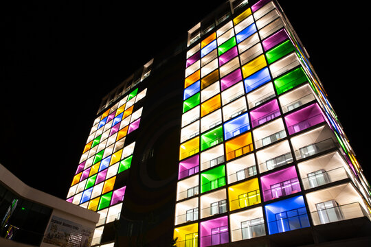 Night view of the International Seybouse Hotel with multi-colored windows and night lighting in Annaba. Republic of Algeria
