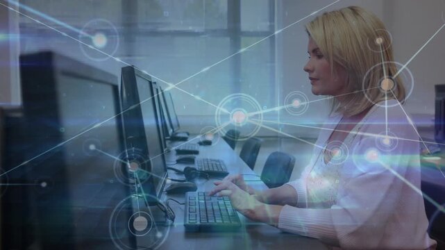 Animation of network of connections over caucasian female teacher using computer in classroom