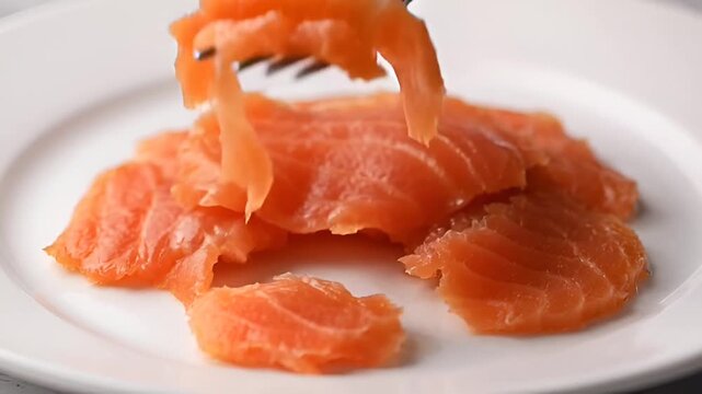 Smoked Salmon Delight: Capturing a culinary moment, delicate slices of succulent, smoked salmon are artfully arranged on a clean plate, ready to be savored.