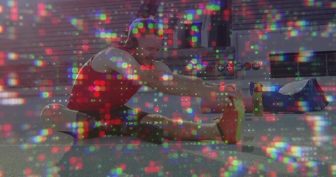 Fitness enthusiast male initiating hamstring stretch, bending right leg and reaching red shoe