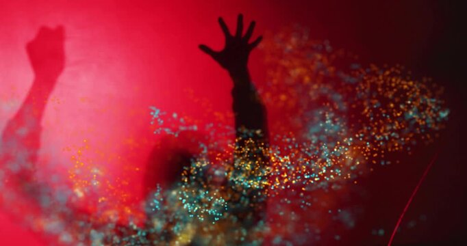 Particles gathering around torso, figure raising arms, swirling orange teal streams forming vortex