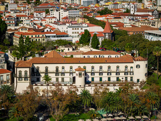 Centro de Apoio Social do Funchal, Madeira, historic military social building surrounded by palm trees in the city center.