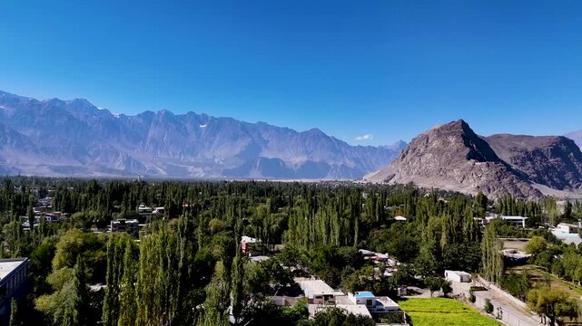 Cinematic aerial view of Skardu Valley, Pakistan, surrounded by stunning mountain landscape