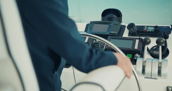 Captain Steering Yacht with Precision at Sea