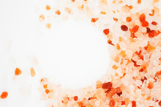 Pink Himalayan salt crystals border with circle copy space on white background