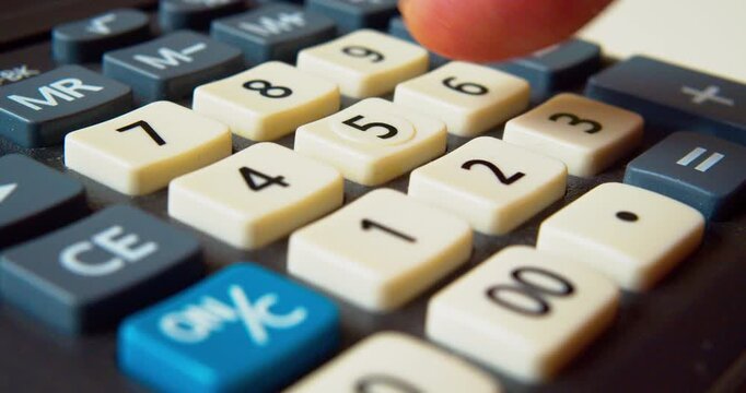 Finger pressing buttons on a calculator, close-up shot.Business concept.