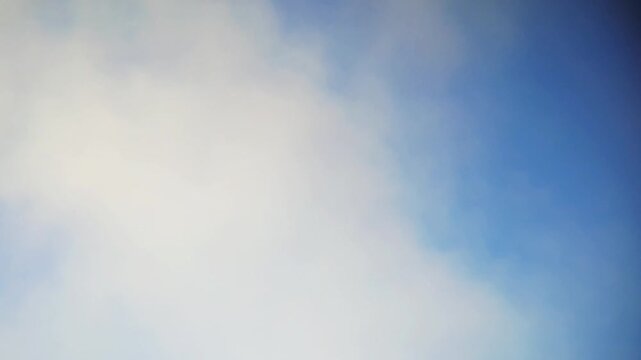 Cinematic timelapse of fluffy white clouds moving across a clear blue sky. Beautiful horizontal shot of bright, clean, and sunny atmosphere during a peaceful day. This footage captures the natural.