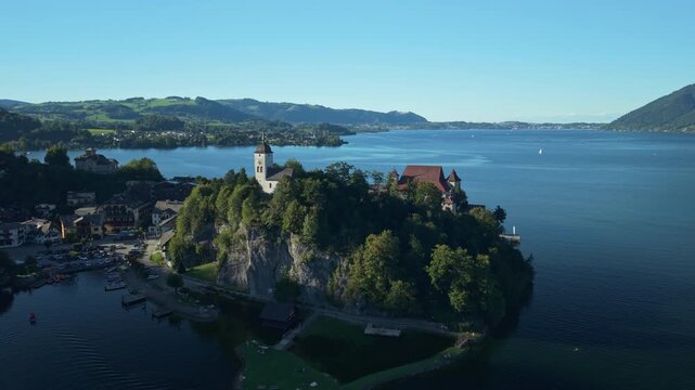 Aerial view of Traunkirchen peninsula and mountains at golden hour light, Austria