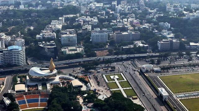 Wide aerial view of Telangana Martyrs Memorial highlighting the symbolic structure, nearby buildings, and vibrant cityscape of Hyderabad Telangana Secretariat area