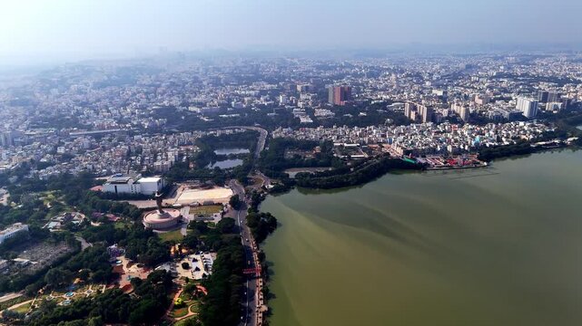 Wide aerial shot of Hyderabad showcasing urban density, lakes, parks, and landmark structures blending into a vast metropolitan skyline. world's largest, 125-foot-tall DR. B. R. Ambedkar statue.