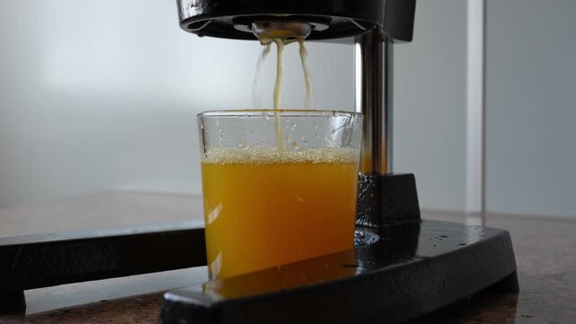Freshly Squeezed Orange Juice Pouring Into Glass