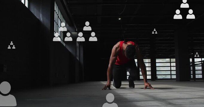 Animation of flowchart of icons over african american athlete taking position to perform sprint