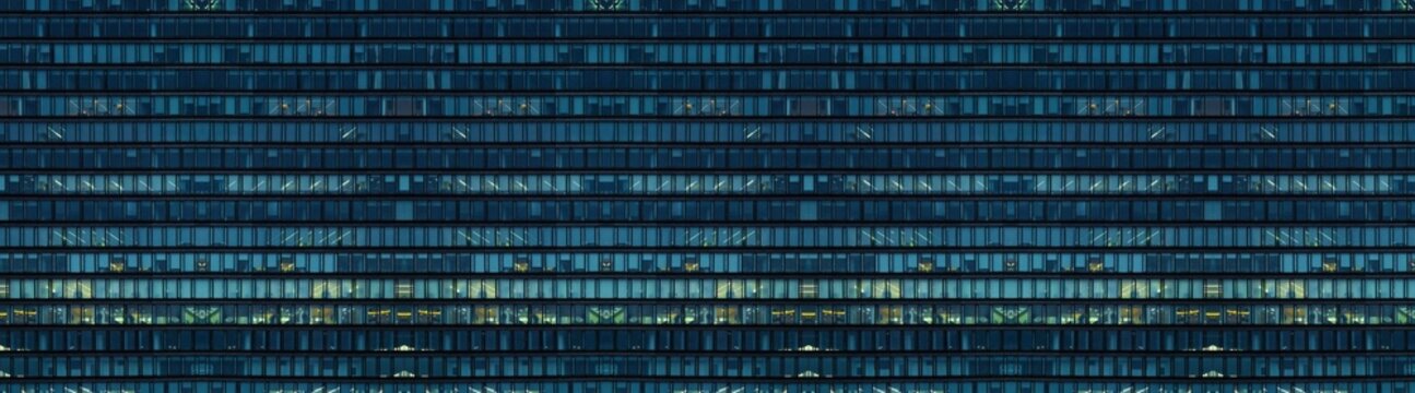 Multi-stories office building at night with worker working overtime. late night at office. lighting and working people within