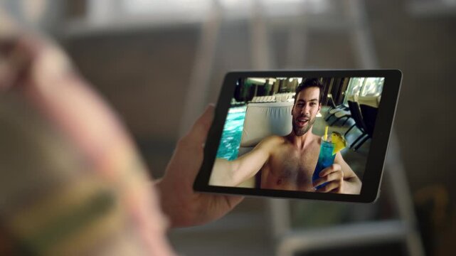 Distance guy toasting tablet screen swimming pool closeup. Mn hands holding pad