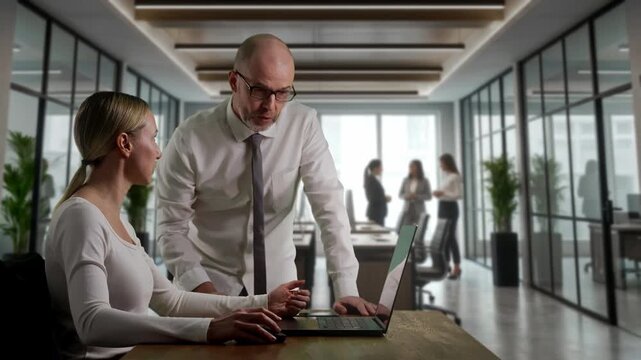Female Analyst Receives Mentorship Guidance. Mentor Instructs Female Strategist During Review Session