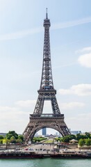 Obraz premium Iconic Eiffel Tower viewed from Seine River with boats nearby